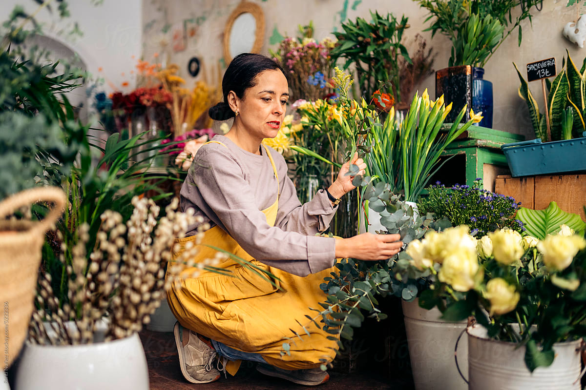Florist Working In Her Flower Shop. by Stocksy Contributor