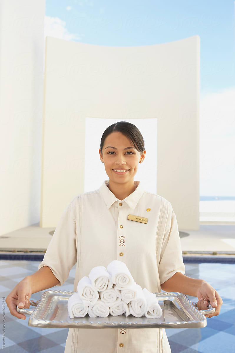 Portrait of hotel service employee holding towels