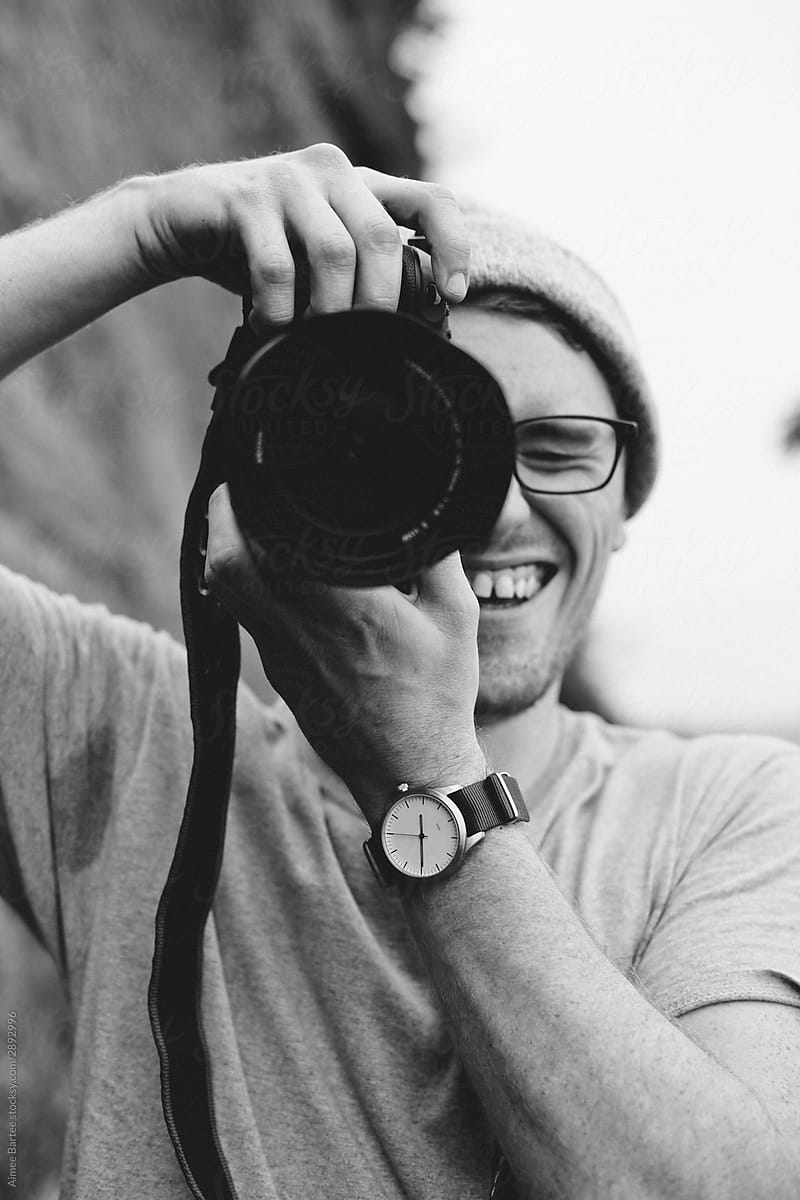 Man Taking Photograph While Smiling