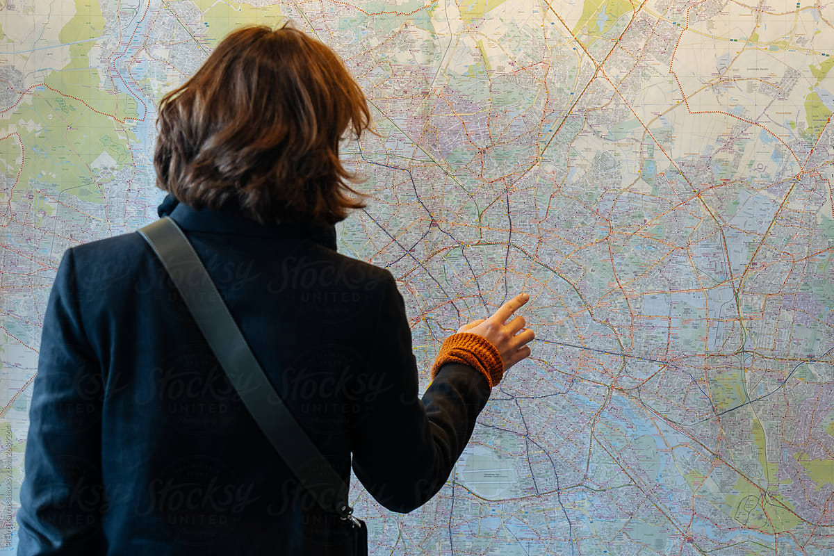 Traveling woman studying town map