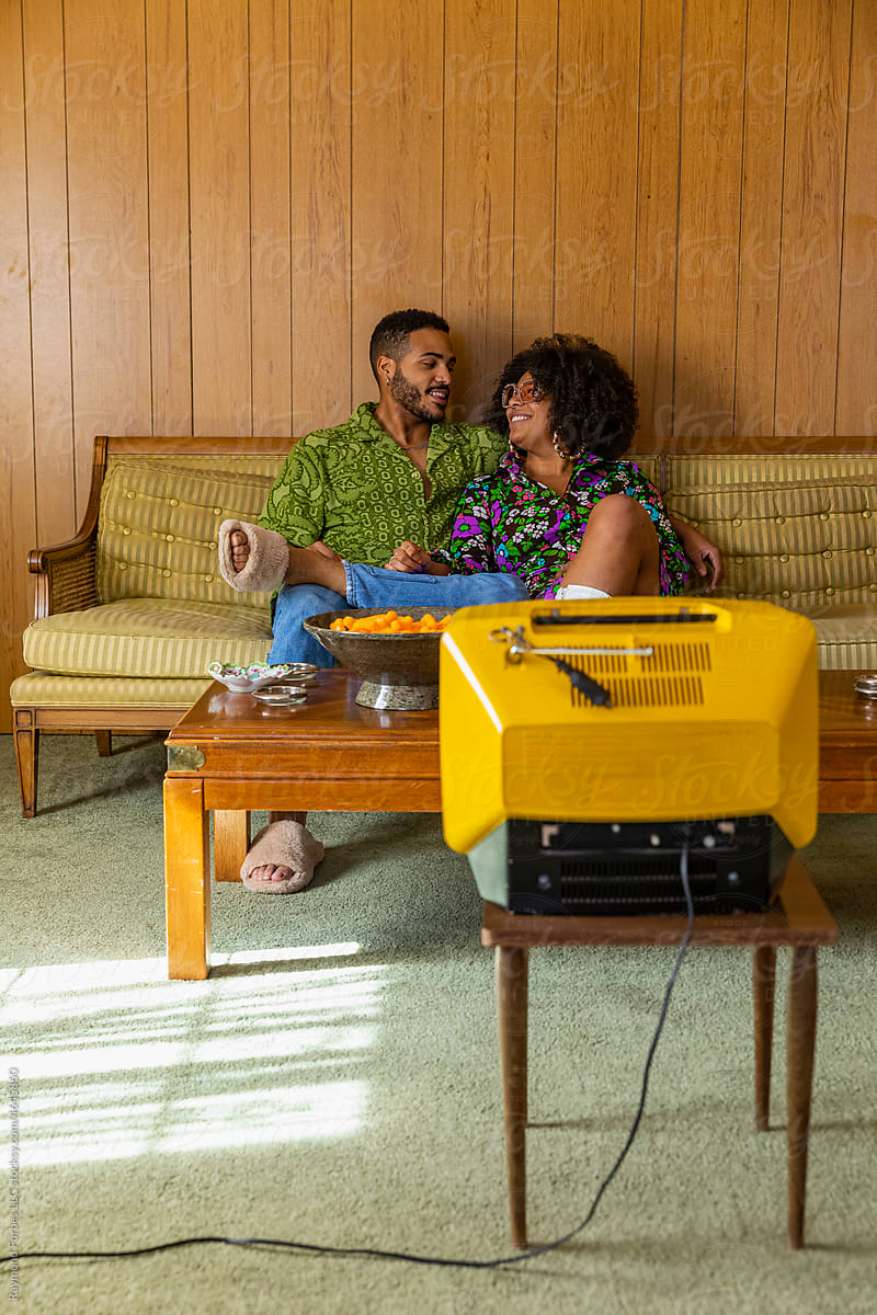 Black Couple in Vintage Living room watching television