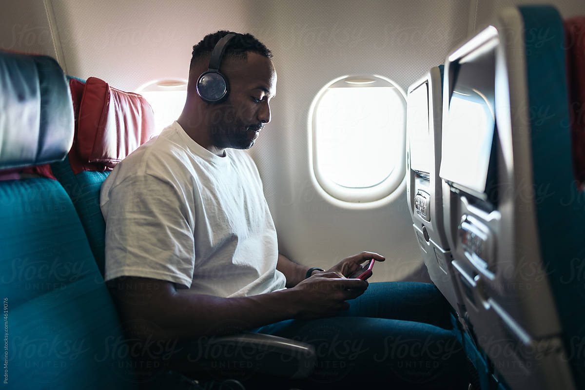 a man listening music during a flight