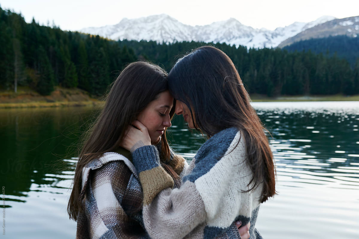 Young Lesbian Couple Sharing A Moment On A Dock By Stocksy 