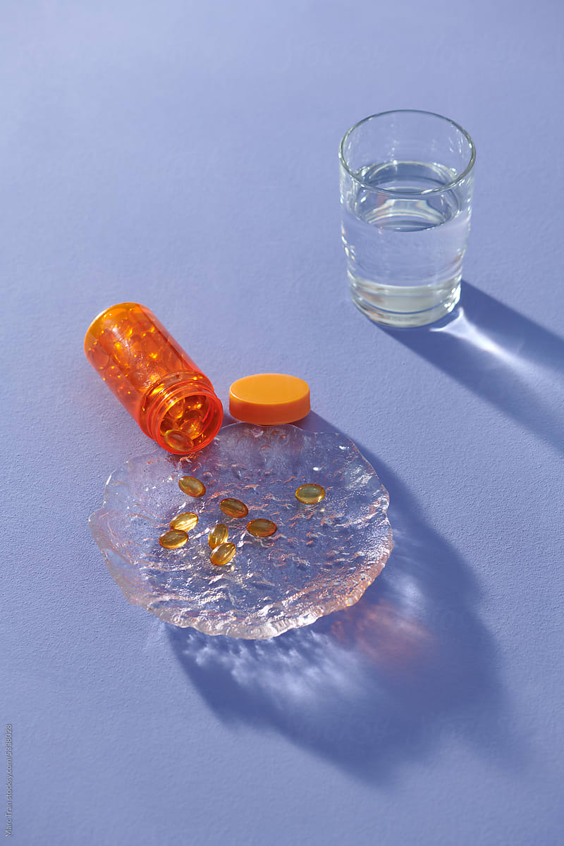 Dietary supplements, Omega 3 capsules and glass of water