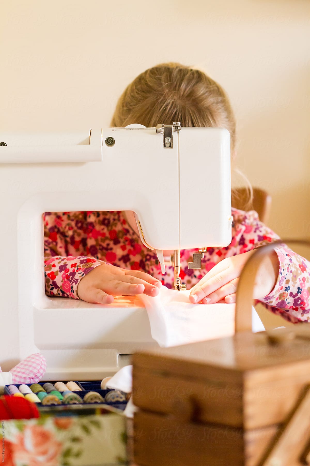 Girl sewing on machine
