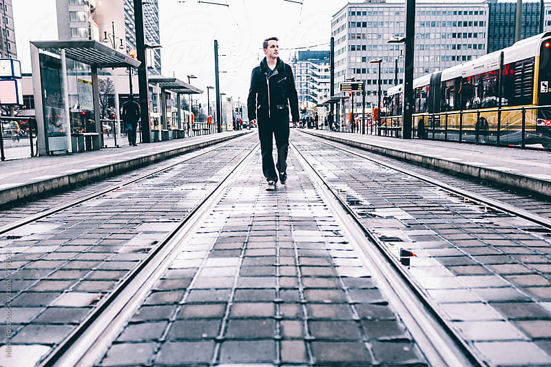 Teenager walking in urban traffic scene in Berlin, Germany