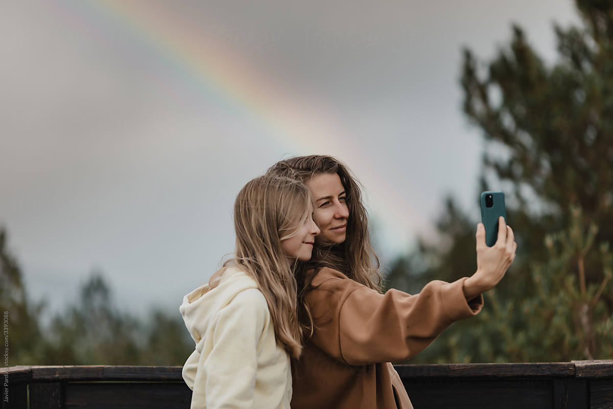 mother and daughter taking selfie.