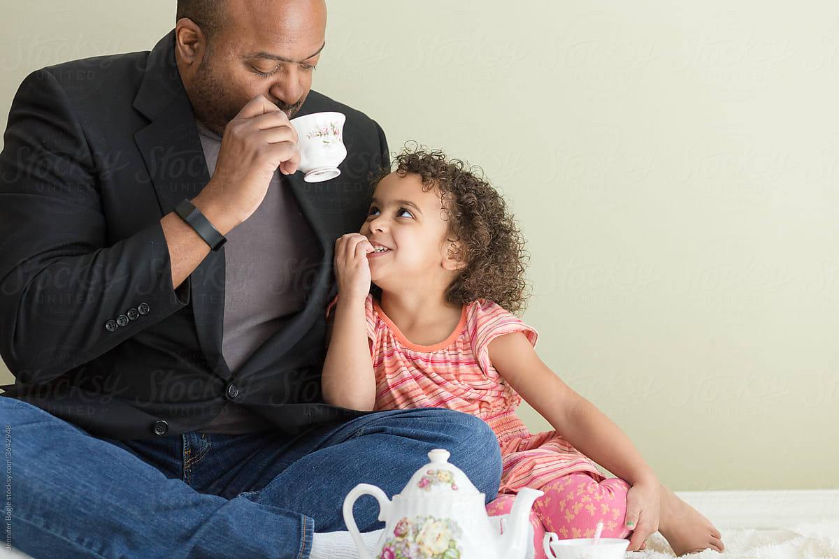 smiling father and daughter tea party