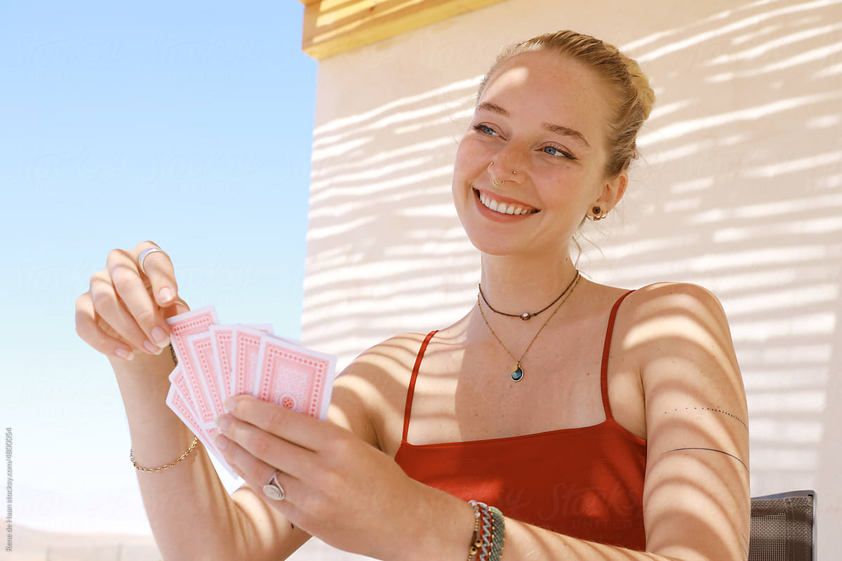 smiling woman playing card game