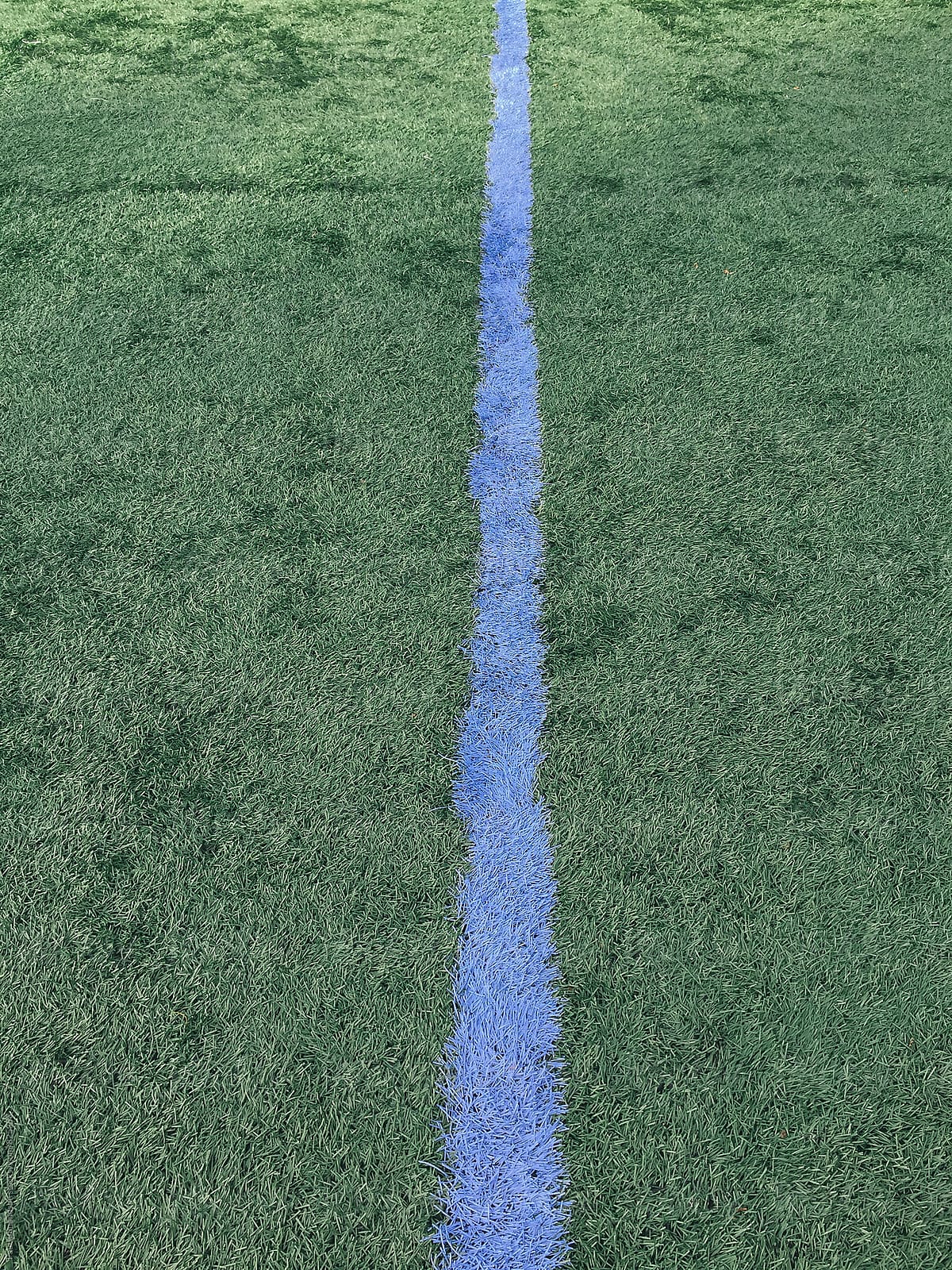 Blue boundary line on artificial turf sports field