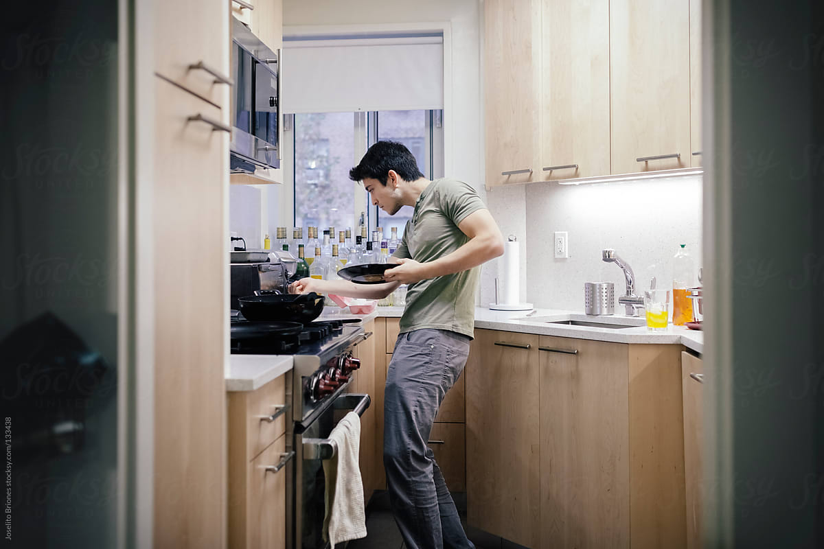 Mexican-American Young Male Student Using Toaster Oven in Making Sandwich