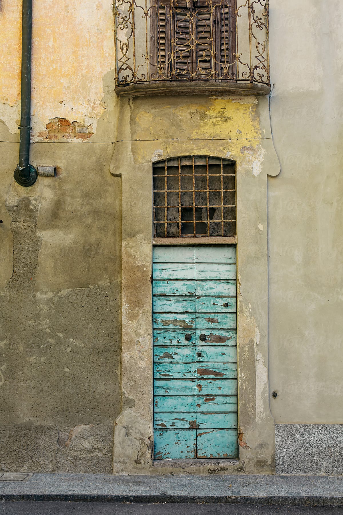 Ancient building front with door and balcony in italian street