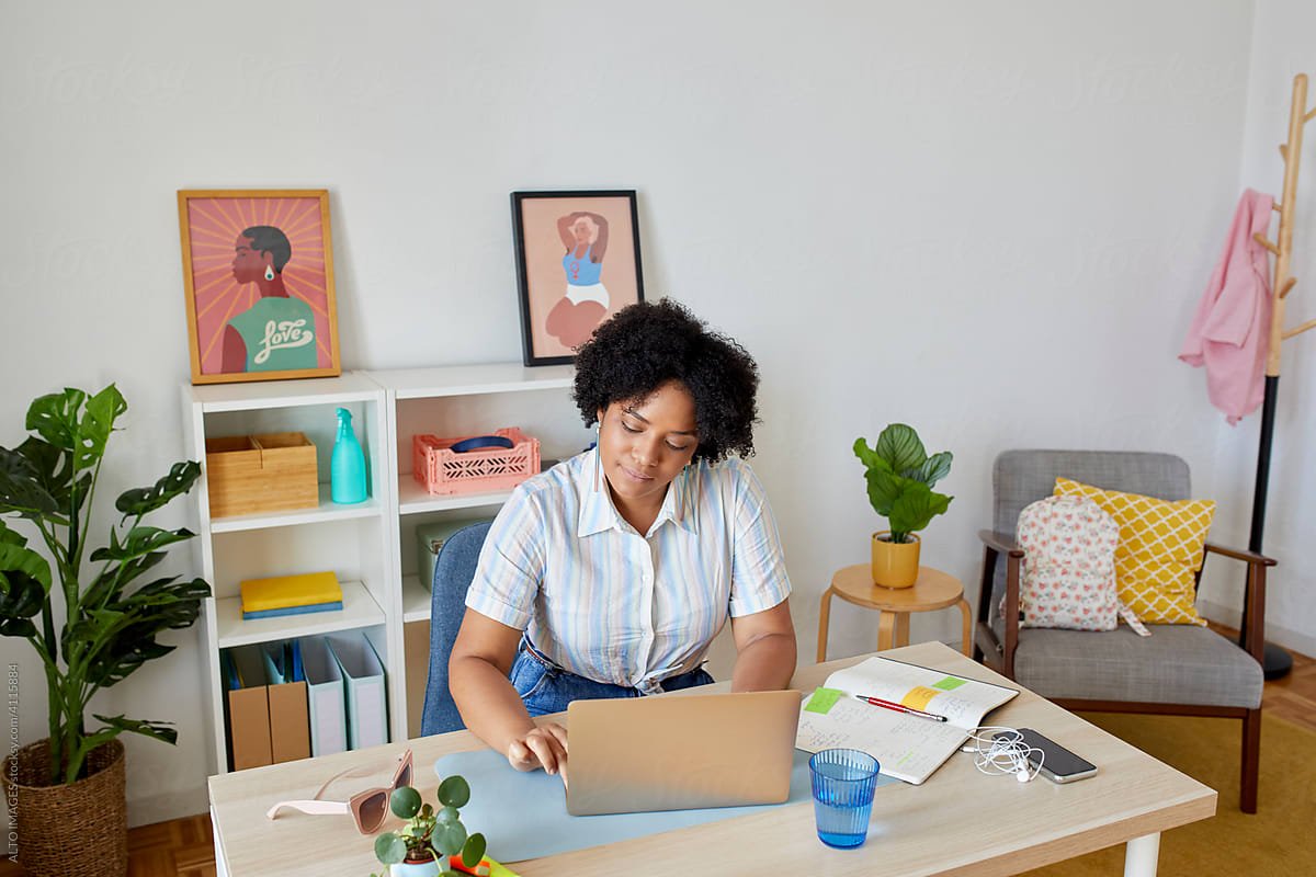 Black freelancer using netbook during work