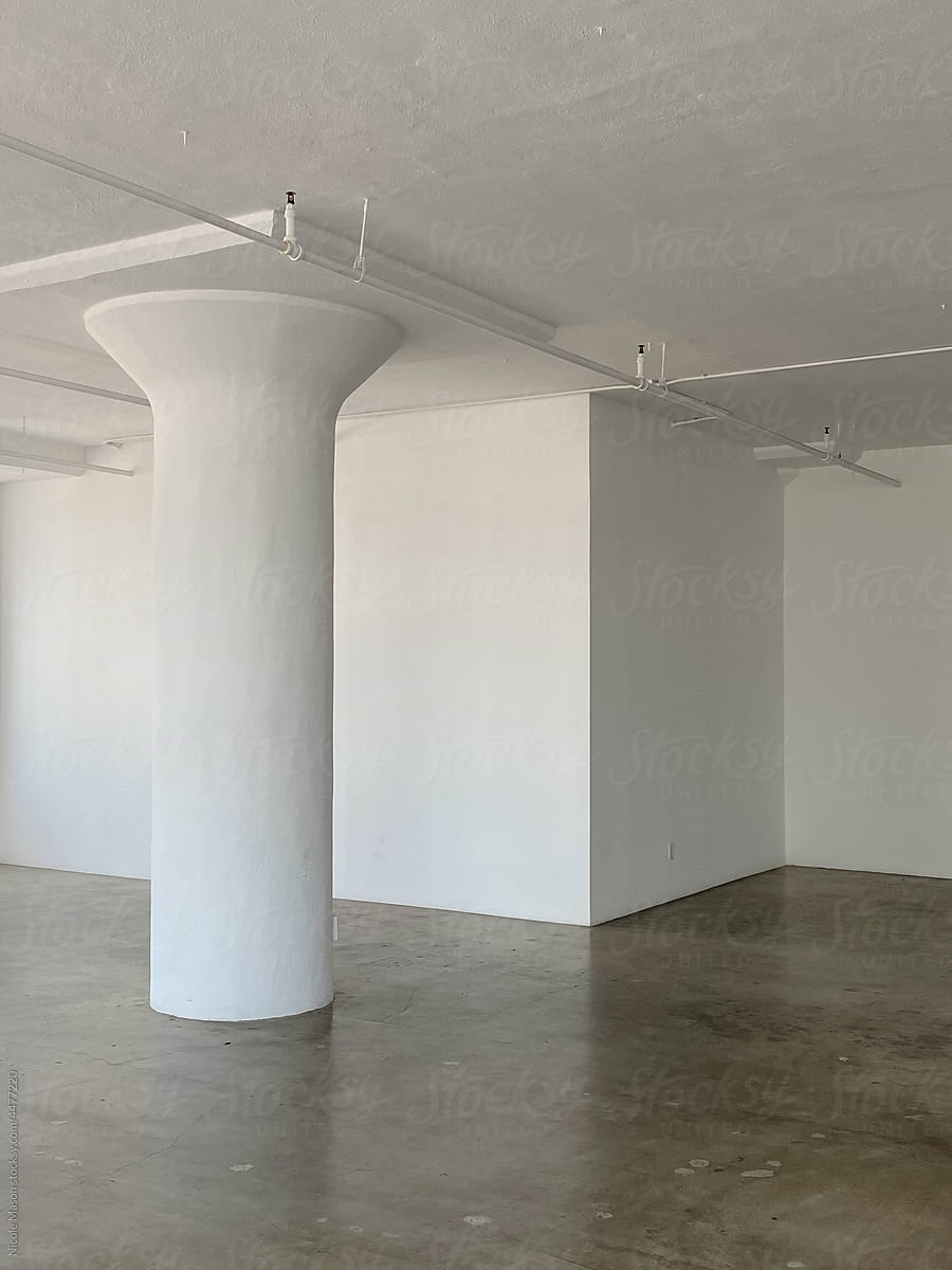empty interior with white walls and concrete floors