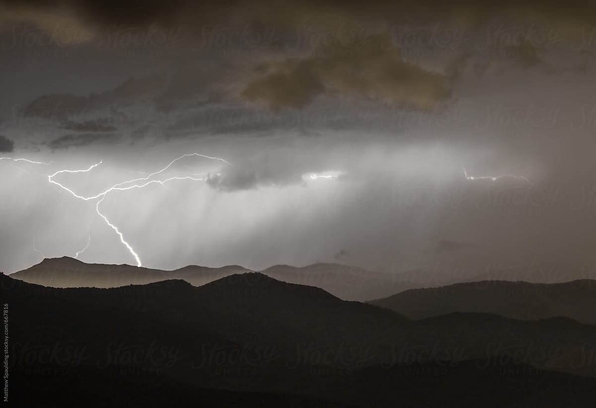 Thunderstorm and lightning over mountains at night