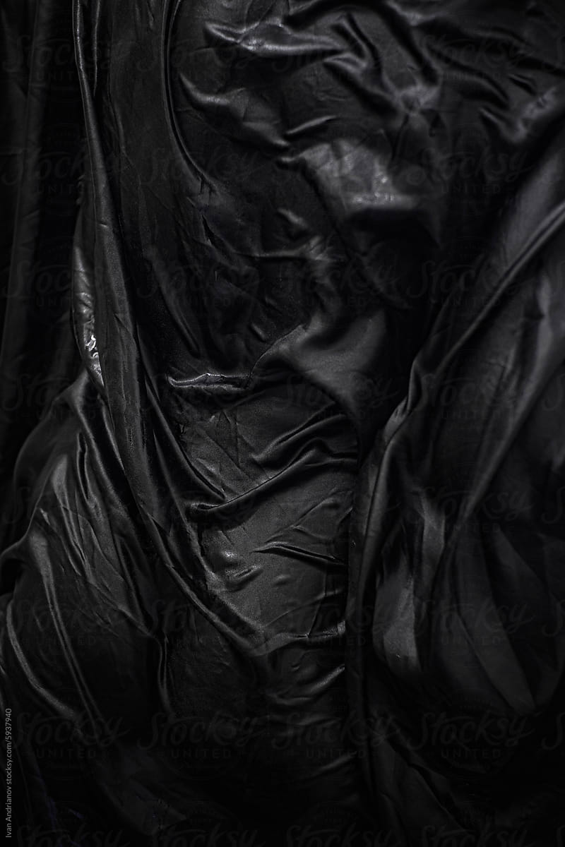 Abstract Wet Body Part In Black Wrinkled Fabric
