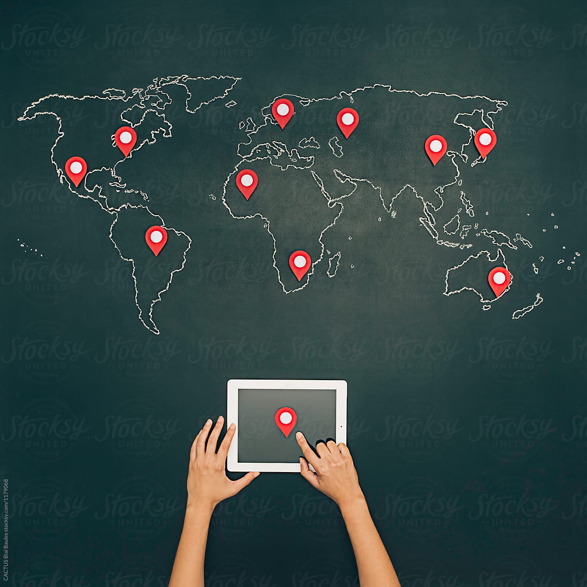 Internet search with tablet. World map on chalkboard with pins.