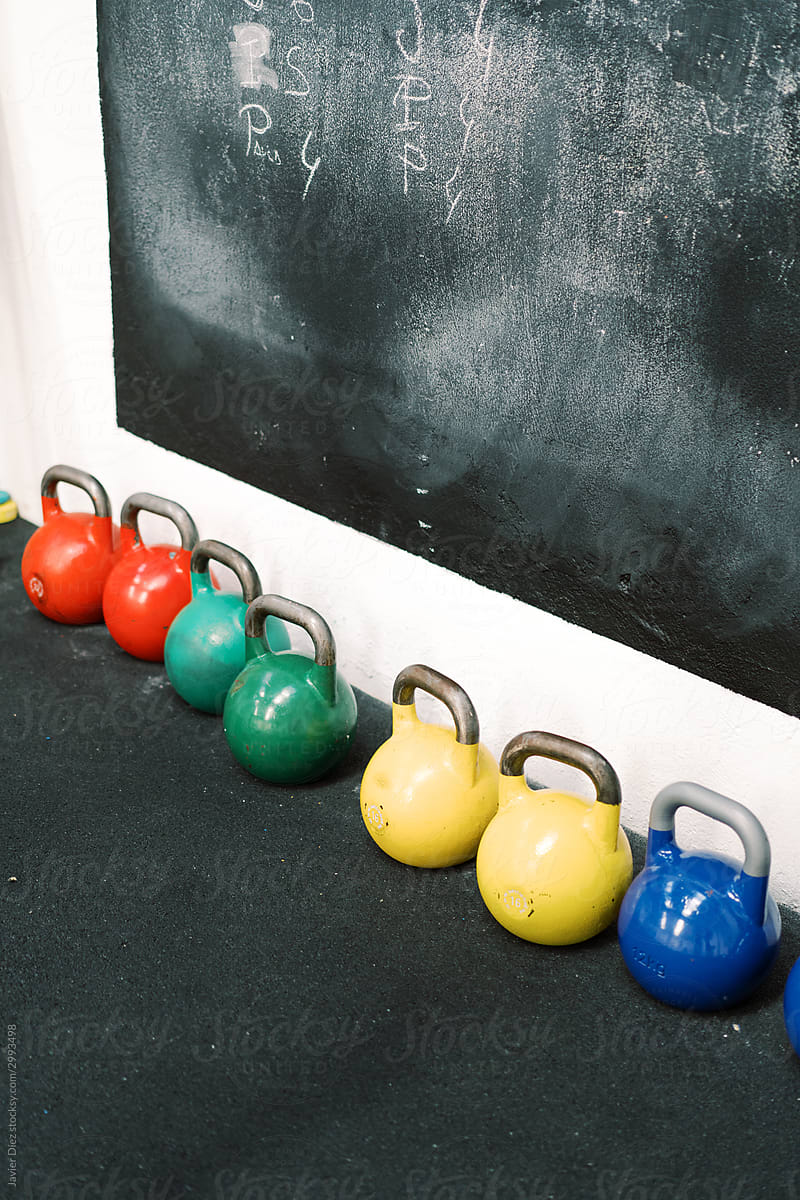 Colorful kettlebells in fitness studio