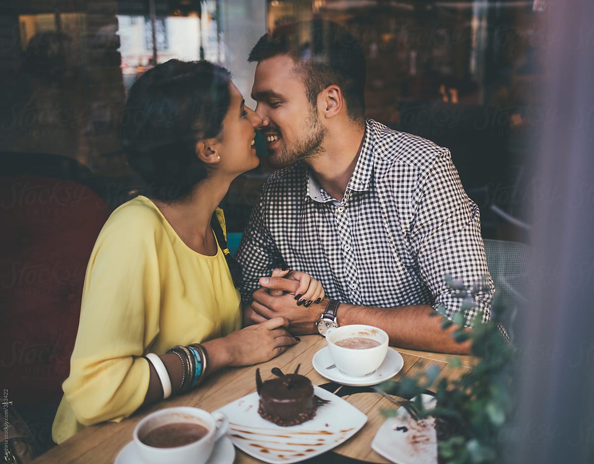 Smiling Couple in Love at a Cafe Together