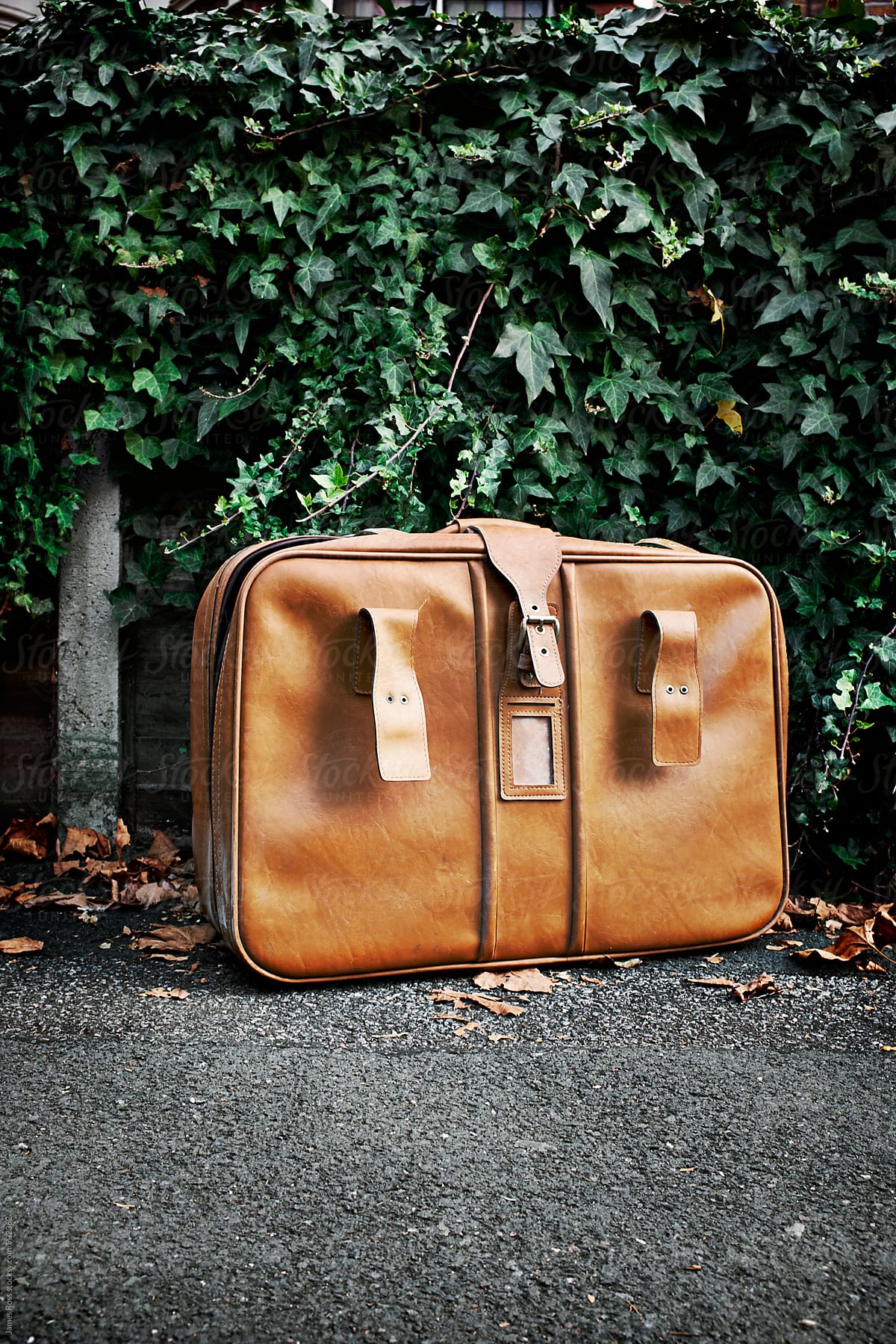 A tan leather suitcase