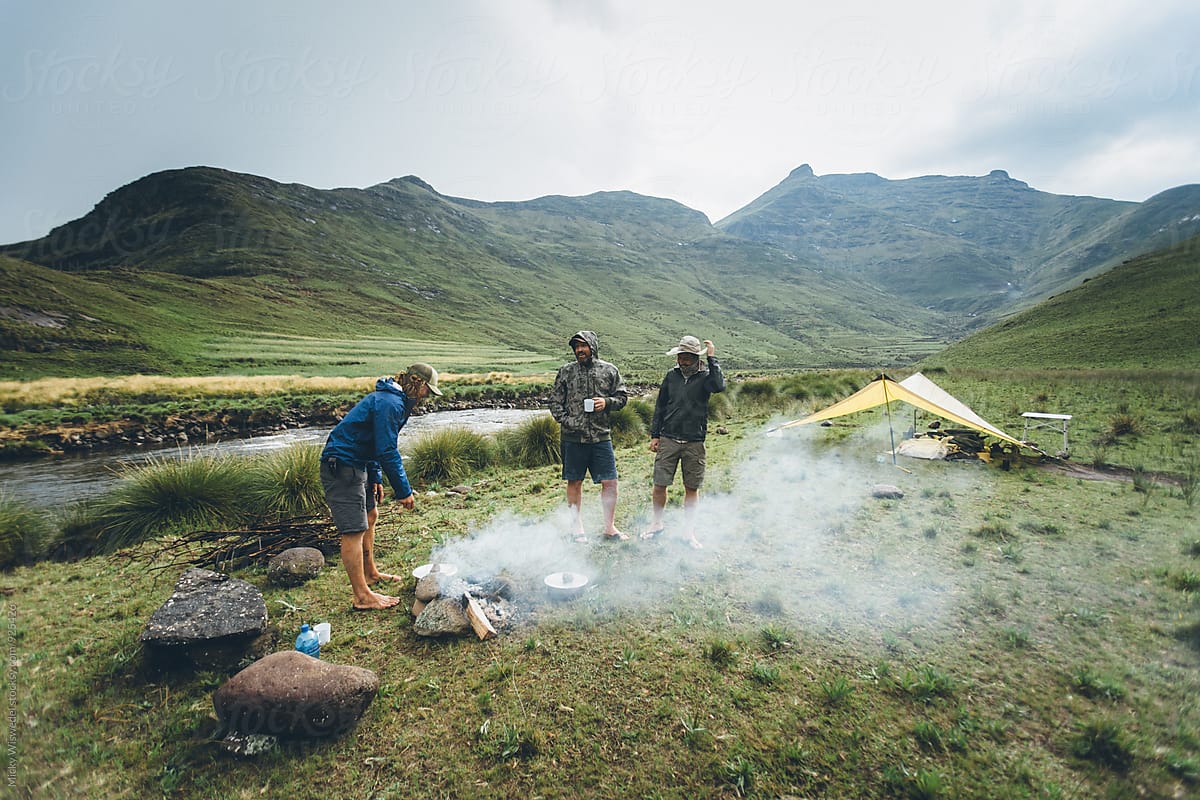 hikers at a campfire in their camp in the mountains