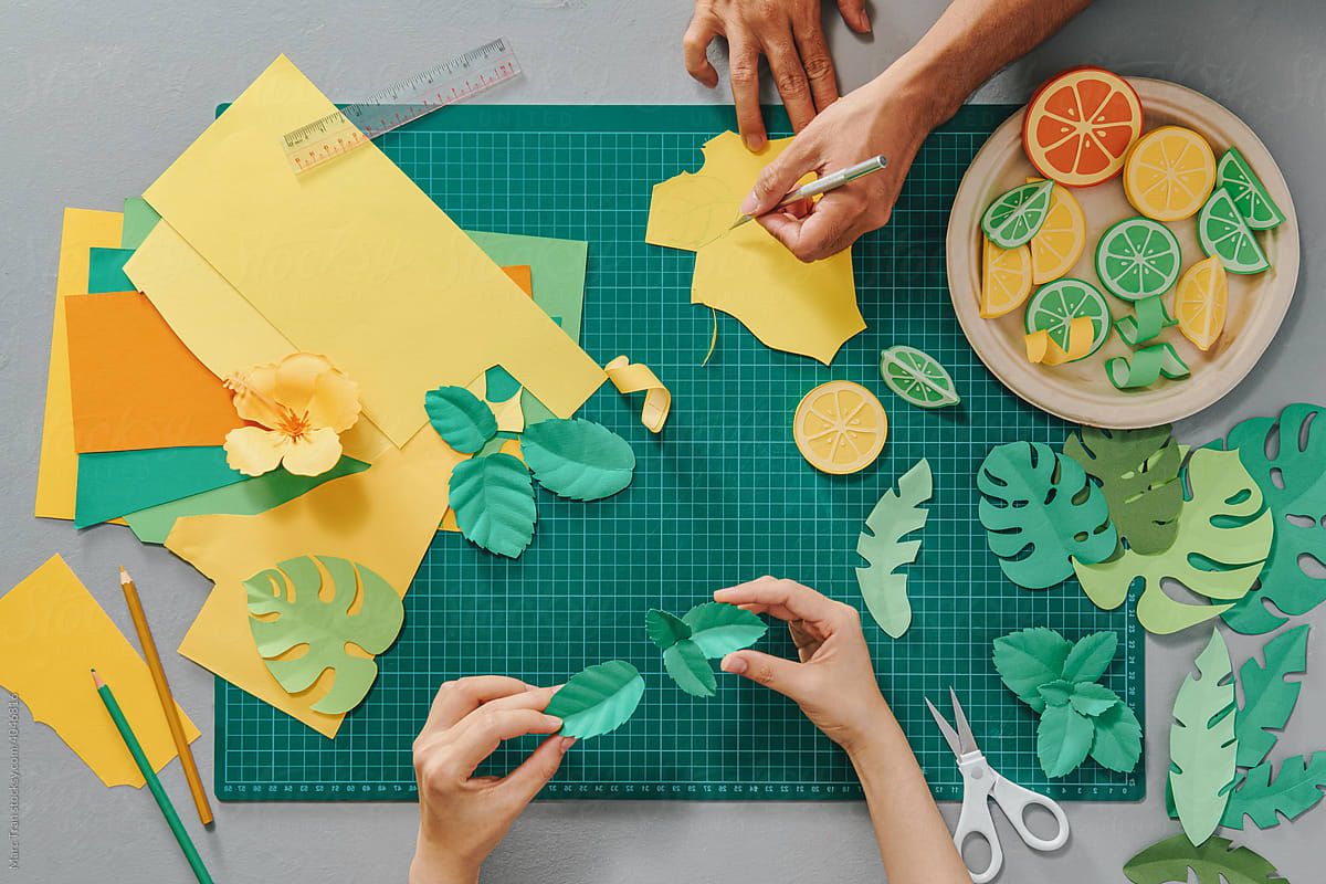 People making paper leaves and fruits craft art work handicraft
