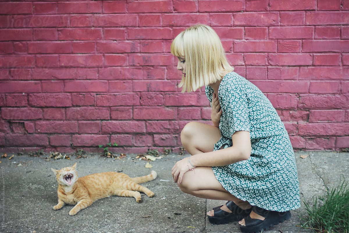 Portrait of a young beautiful female model with cat