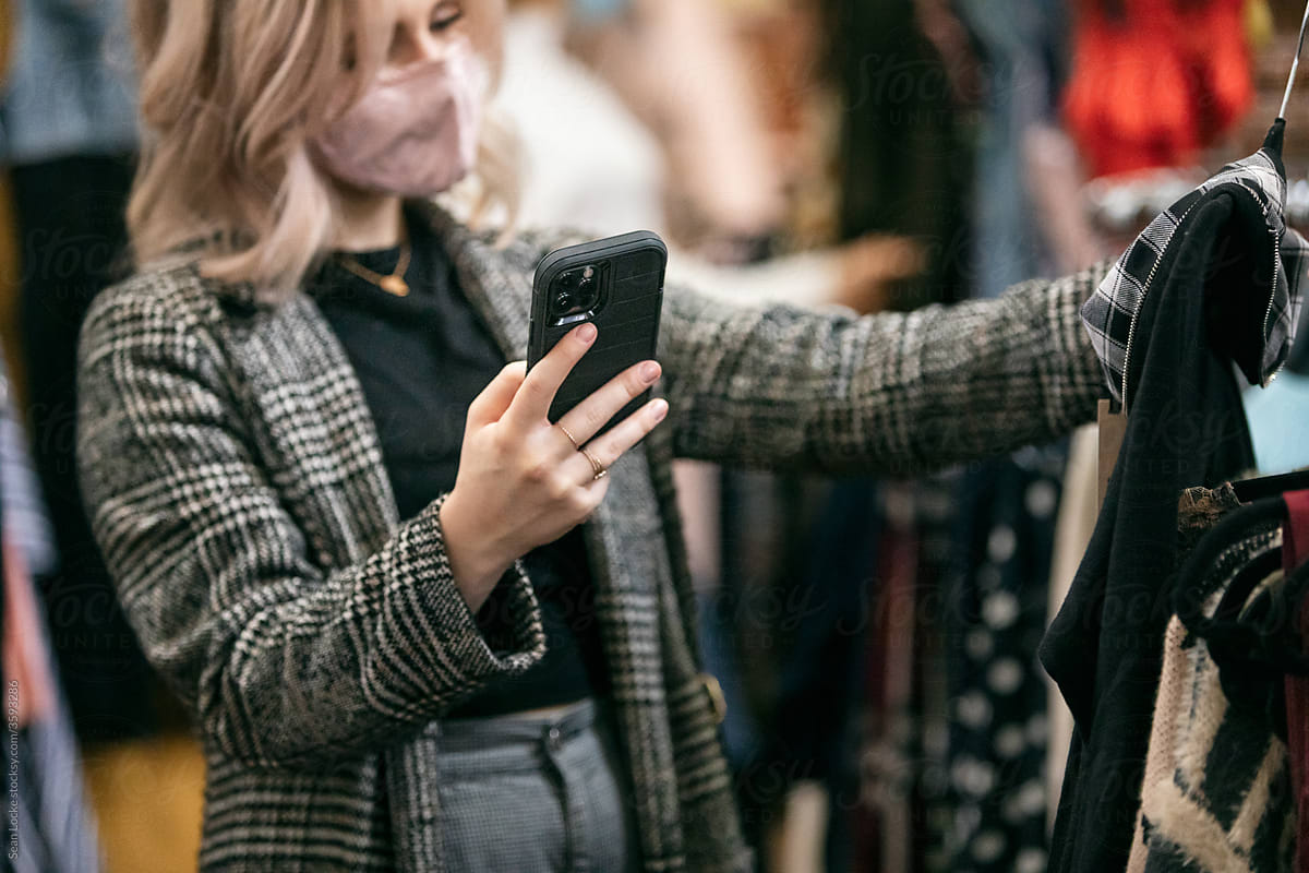 Shopping: Woman With Face Mask Checks Price On Phone