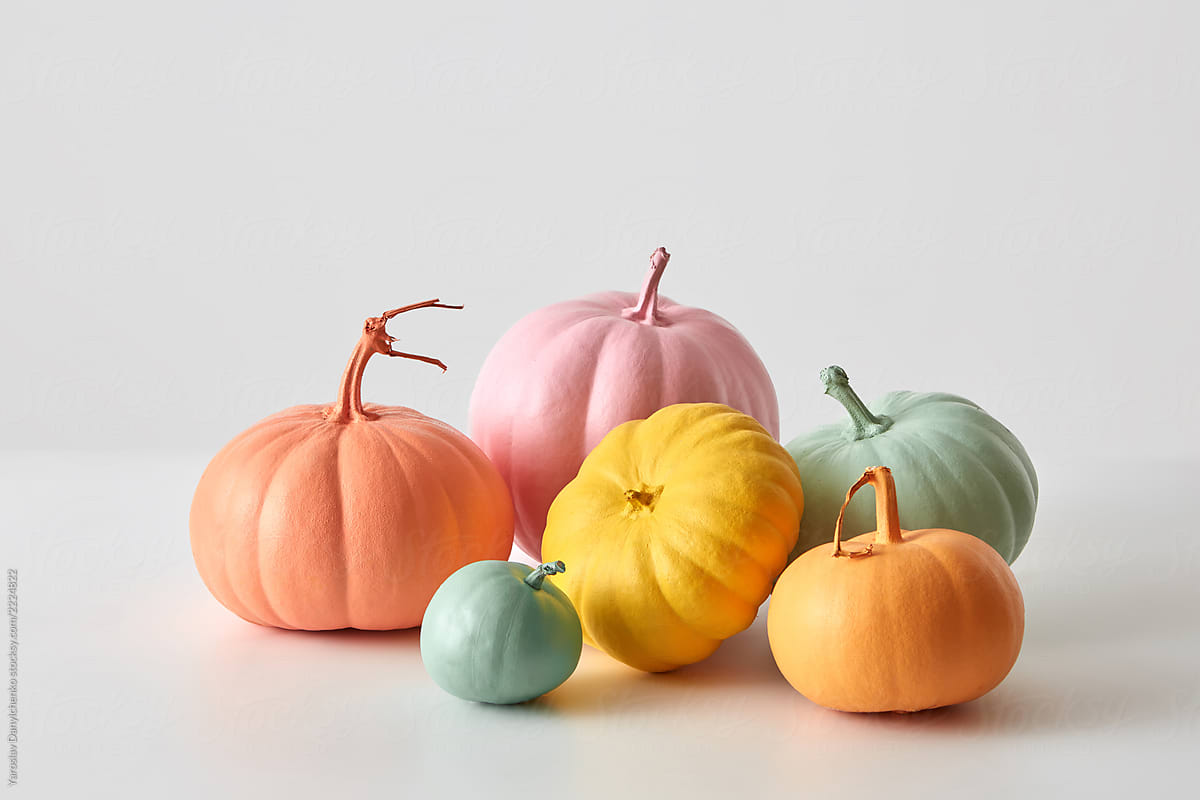Halloween creative handmade painted pumpkins in a various colors isolated on a white background with copy space. Greeting card
