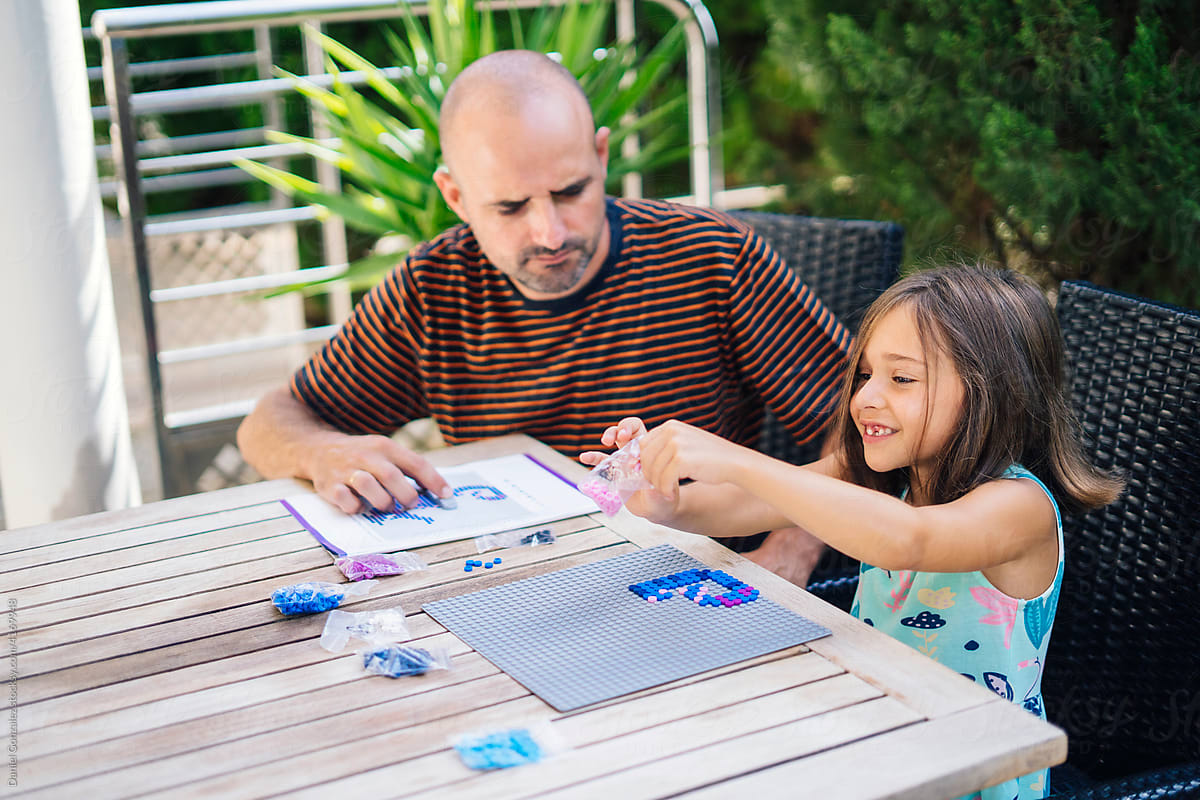 Smiling girl with father playing game