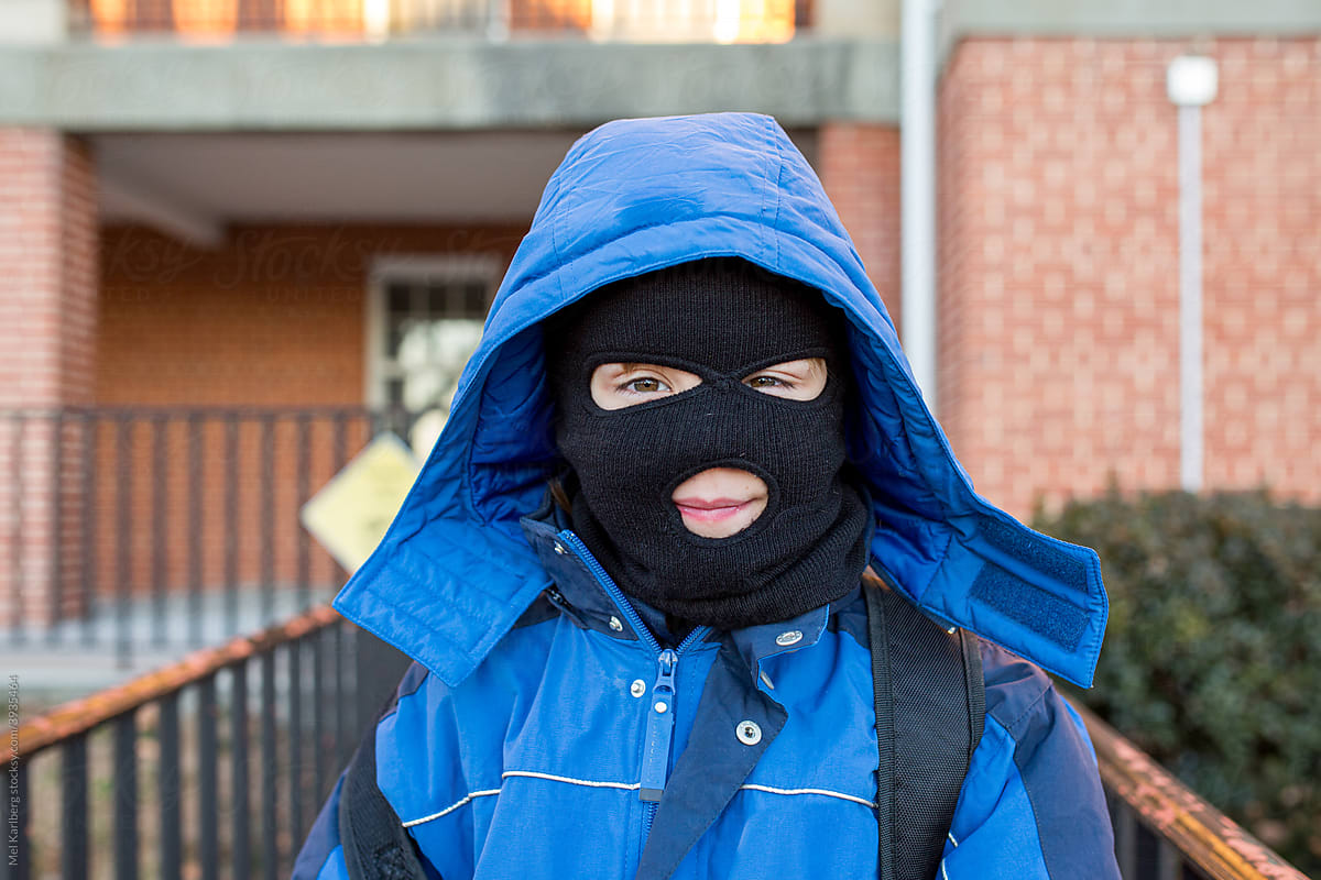 Young boy in ski mask and winter coat