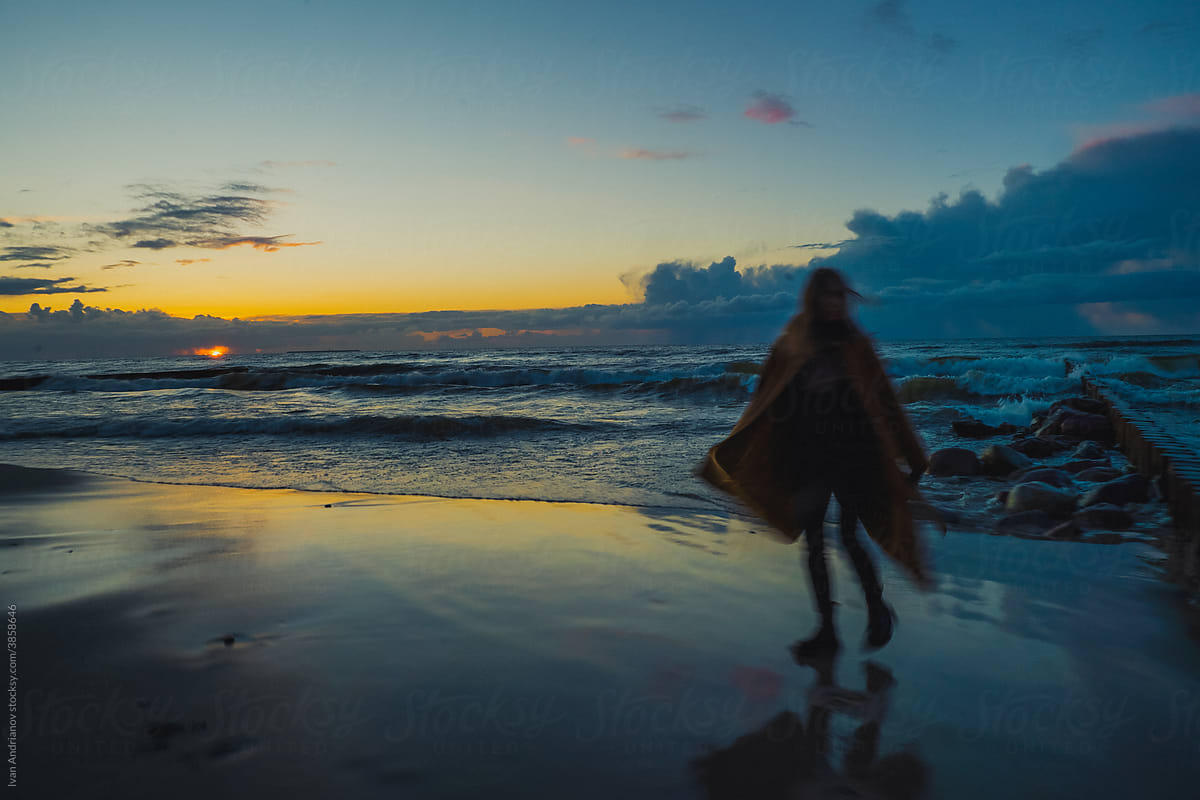 Woman Motion Blur at sunset by the sea
