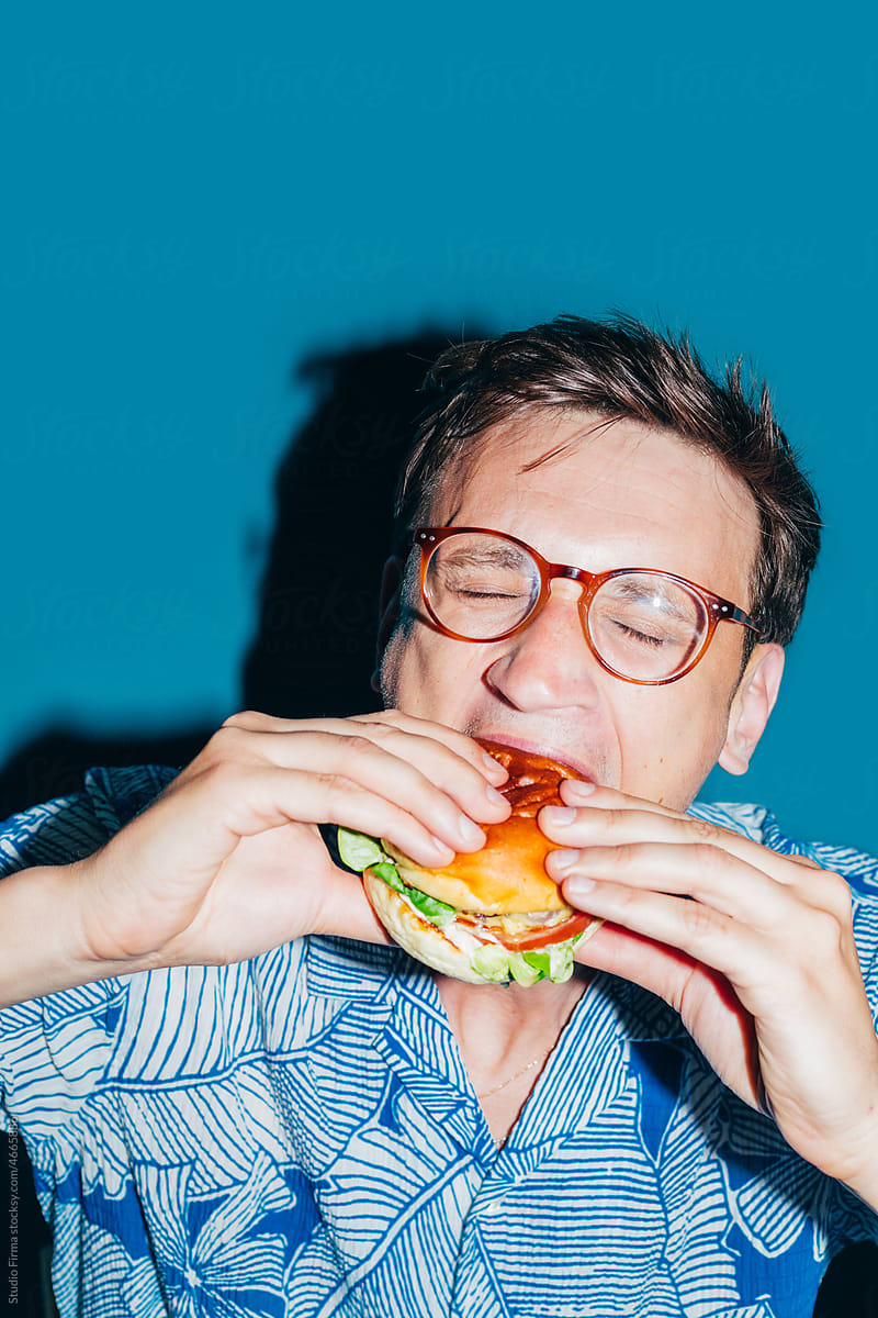 Man Eating Hamburger