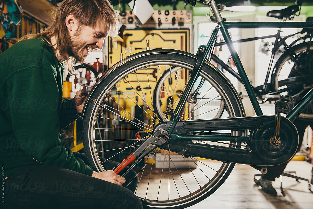 Young mechanic working on a back wheel