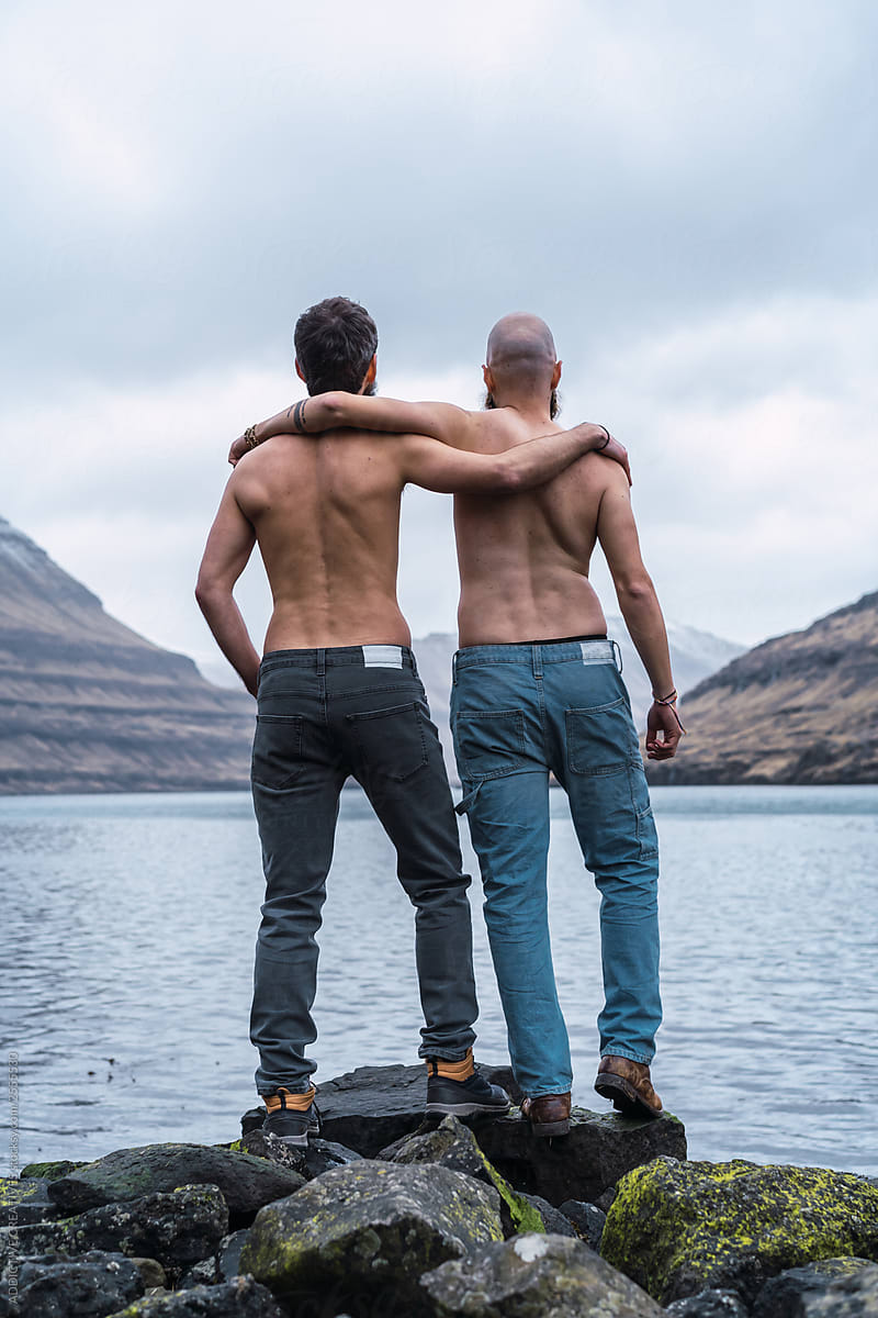 Shirtless Men Hugging On Lake Shore By Addictive Creatives