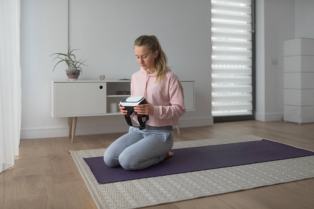 Female yogi holding virtual reality gear