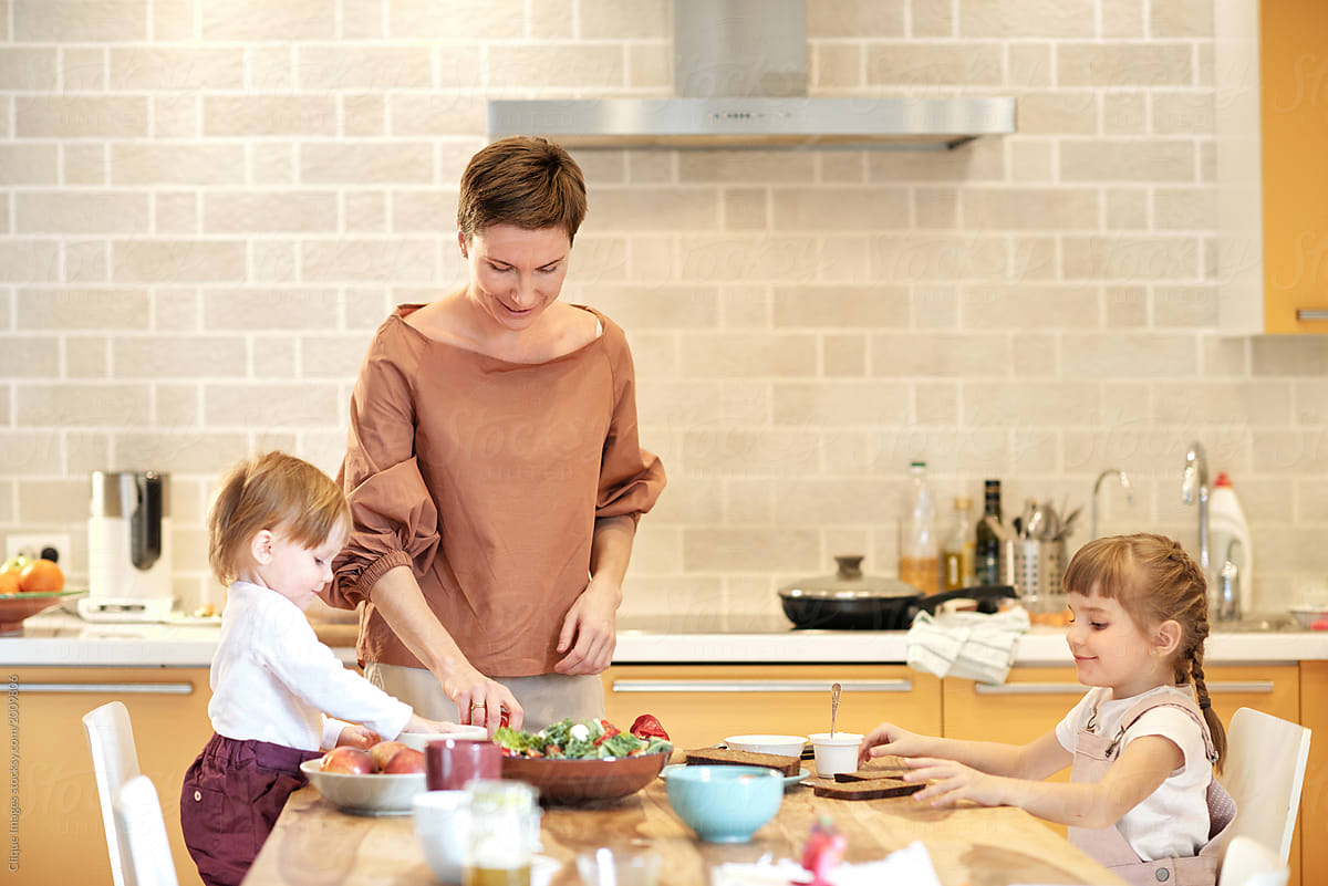 Woman Preparing Lunch With Kids