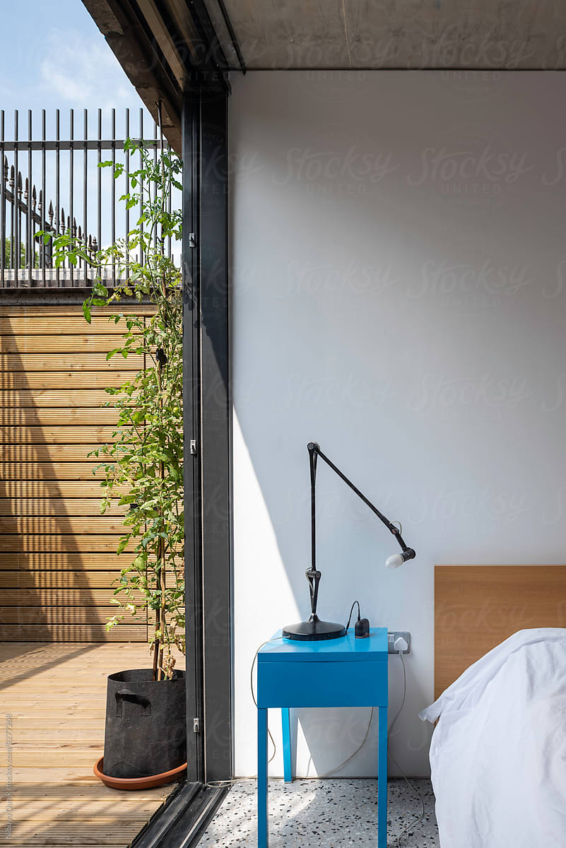 Bedroom interior with blue modern bedside table and the terrace