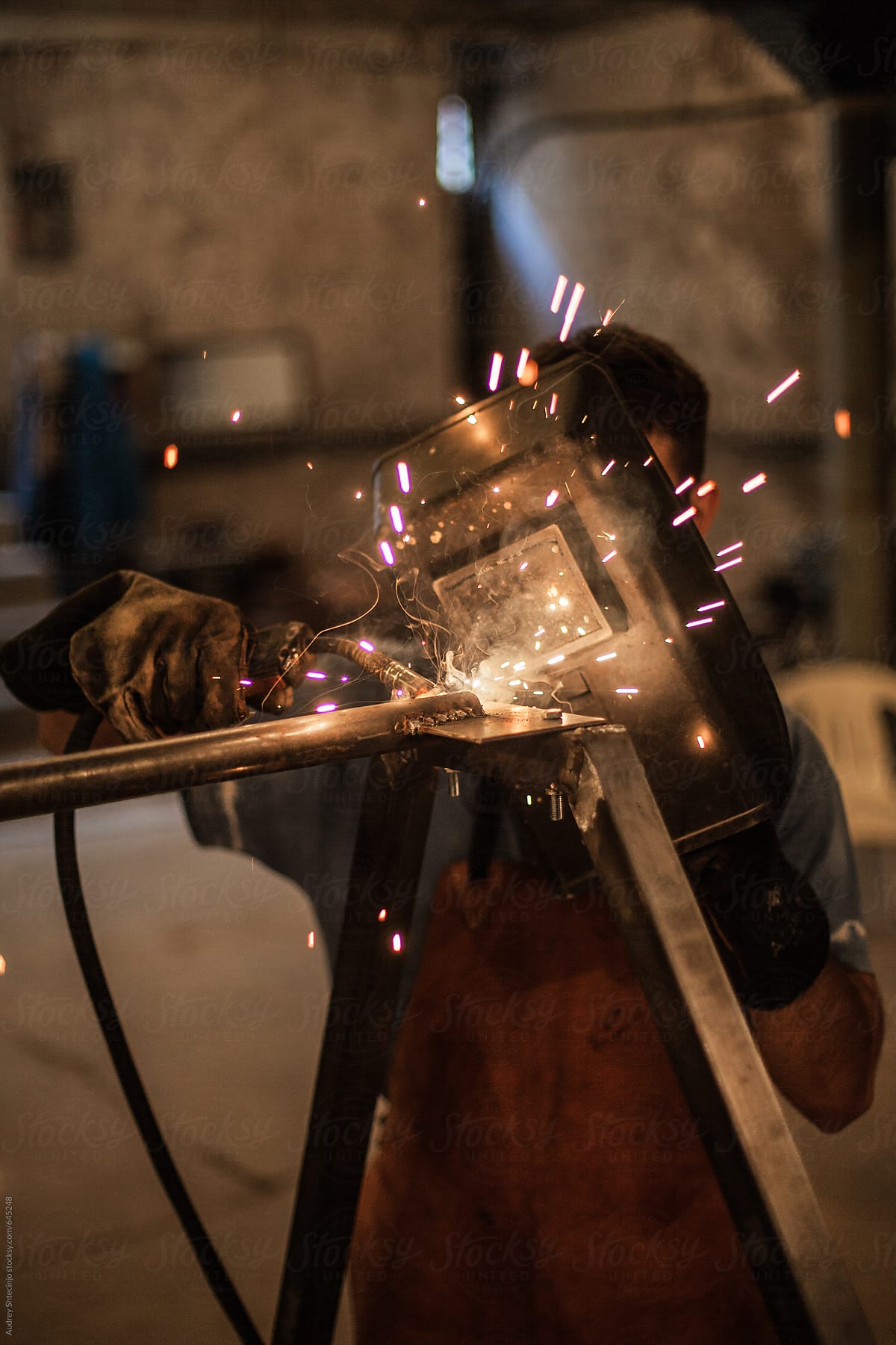 Man welding in his workshop.