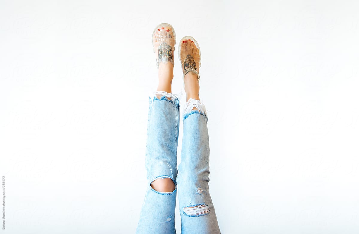 Female Legs with ripped jeans and sandals