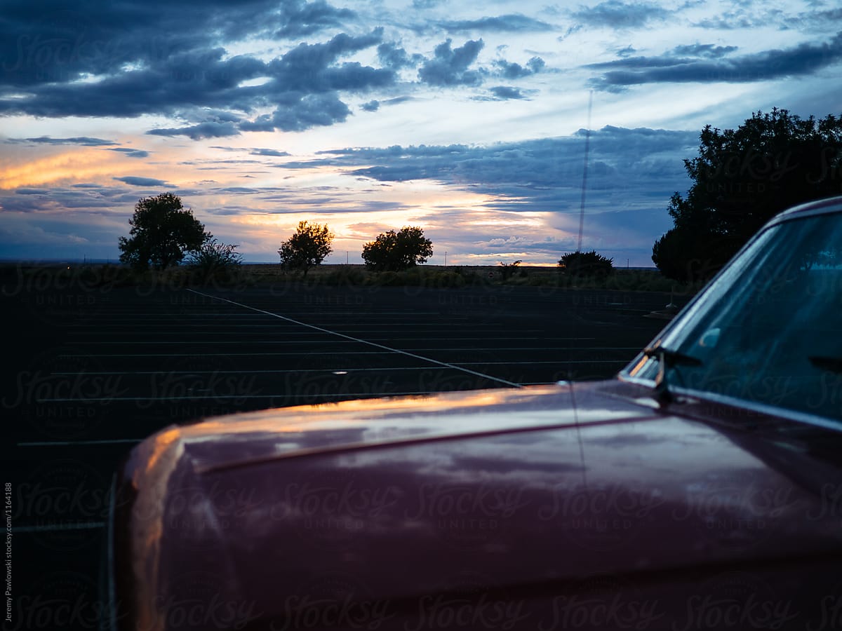 Sunset over the hood of a red pickup truck