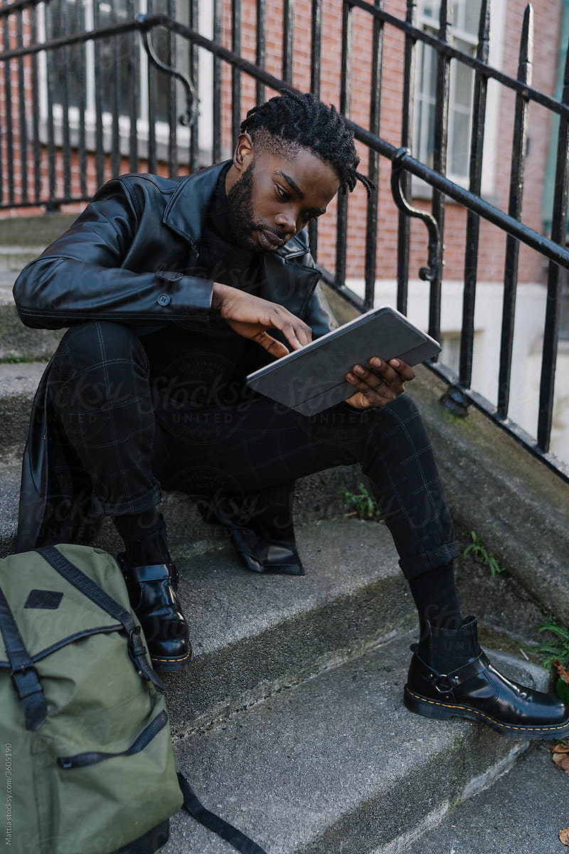 Afrom Man using Digital Tablet Outdoors