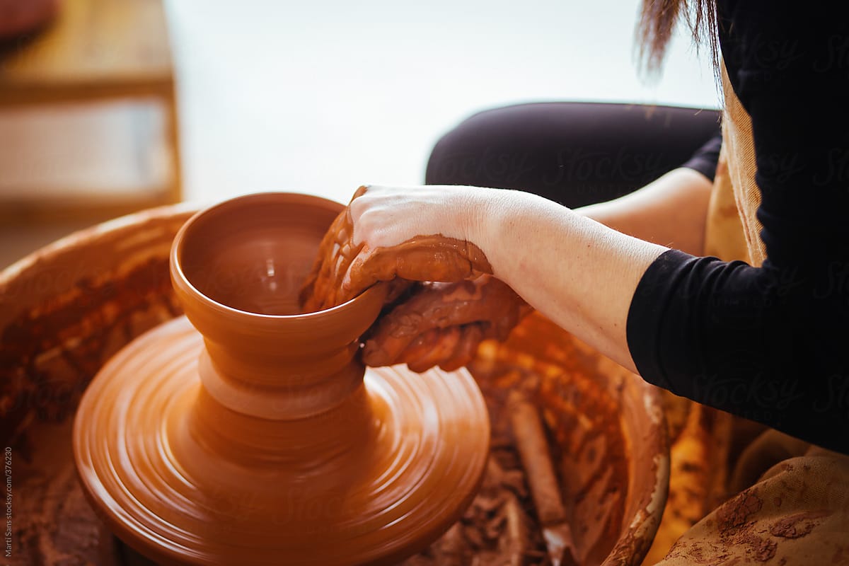 Craftswoman turning some clay