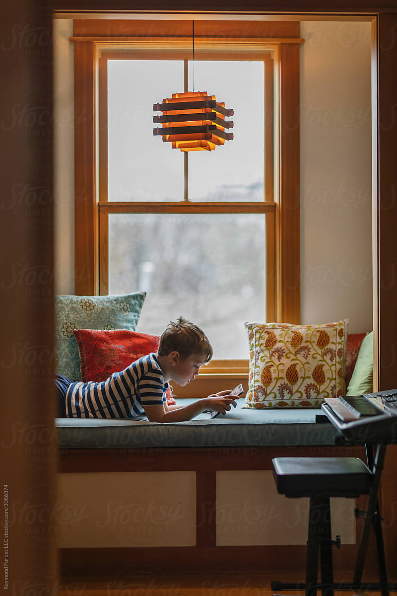 Boy at Home playing on Tablet Computer  on video call