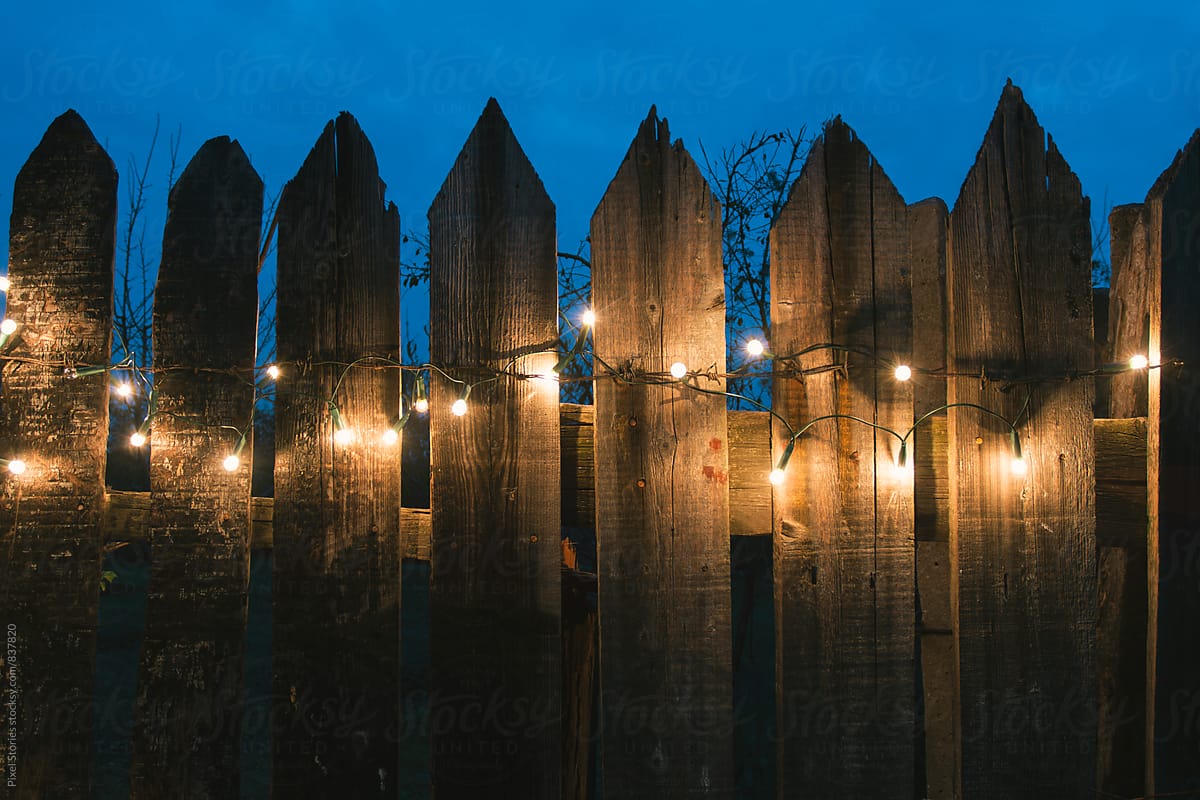 Christmas lights on old wooden fence