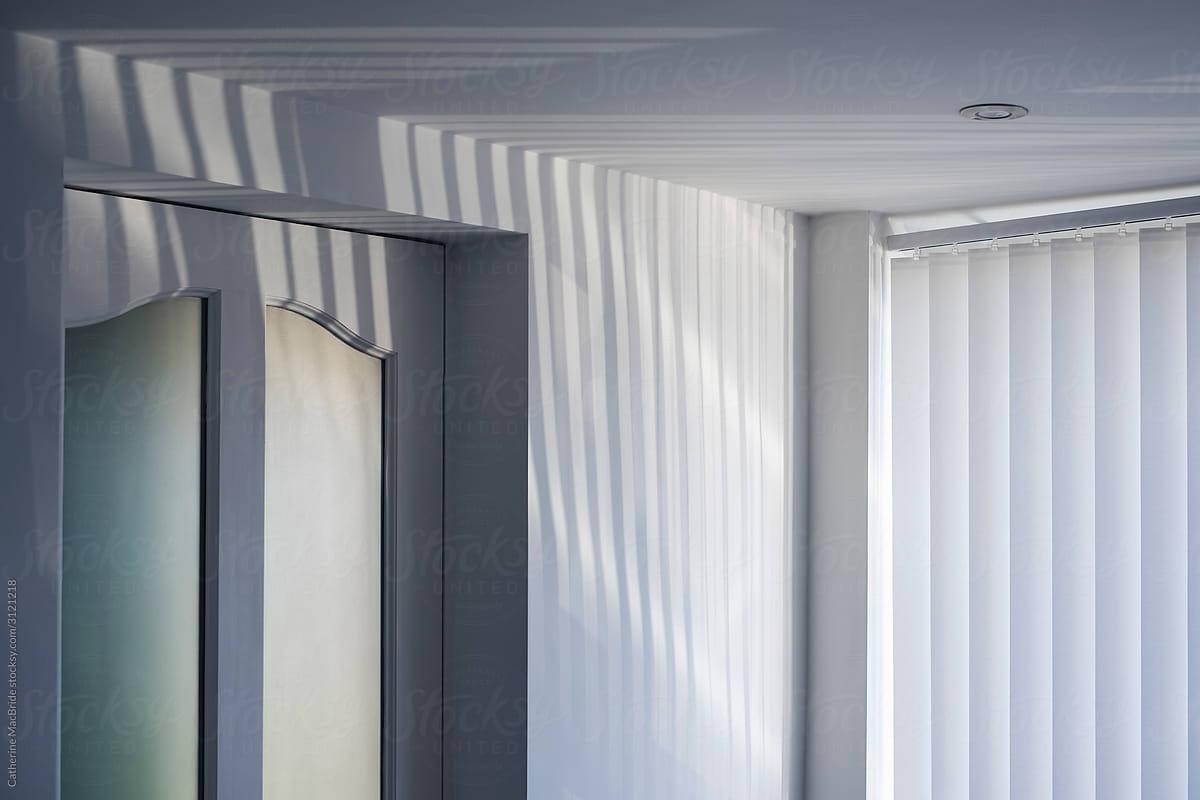 The corner of a room in light and shadow stripes