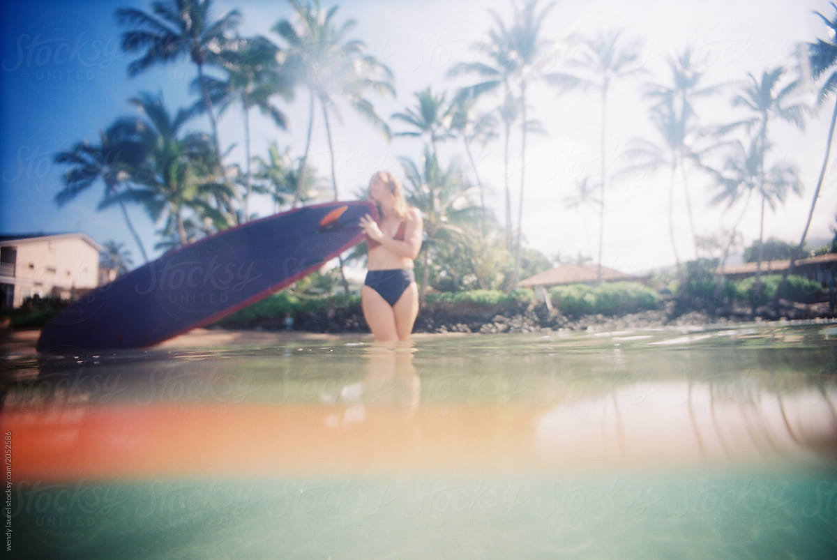 Maui surfer girl in blue ocean