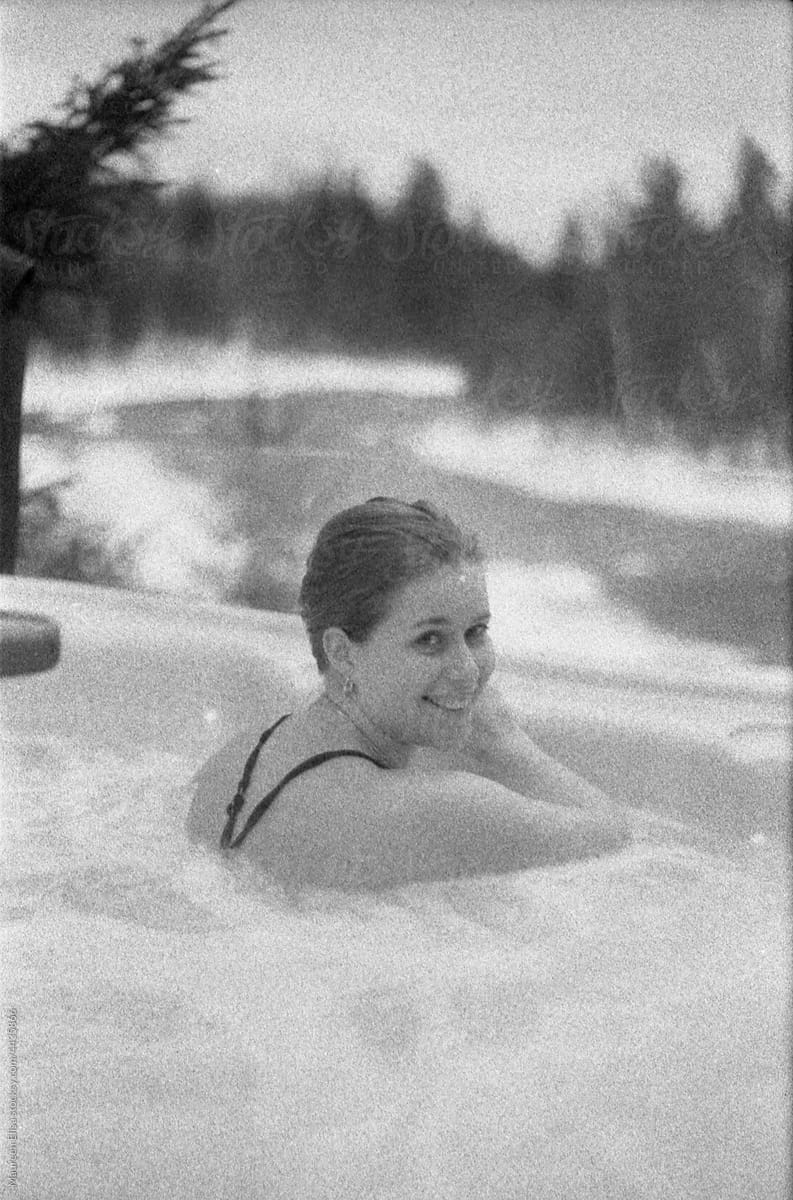 Woman in a hot tub during winter