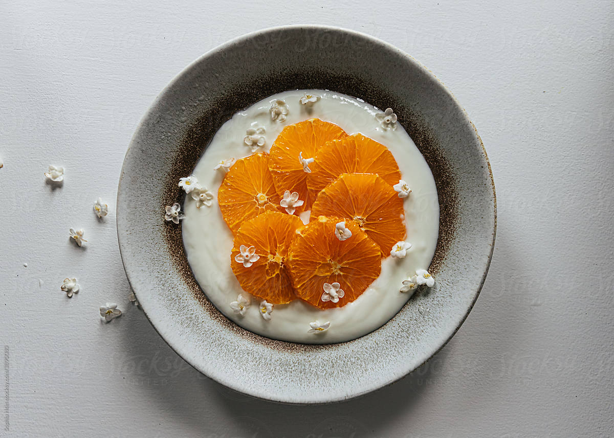 Sliced orange on bowl of yogurt