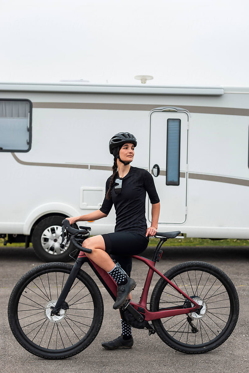 Cyclist riding electric bike near camper van